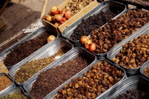 A lively market stall in Pakistan offering a variety of dried fruits and spices, showcasing cultural richness.